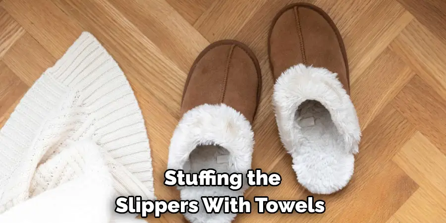 Stuffing the Slippers With Towels 