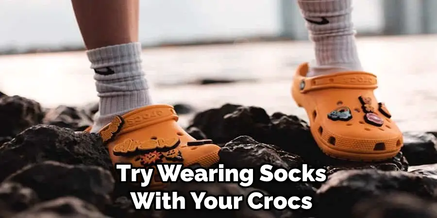 try wearing socks with your Crocs